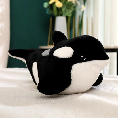 Orca plushie placed on bedroom pillow as sea animal room decor