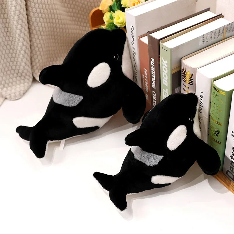 Orca stuffed animal used as cuddle pillow during movie night