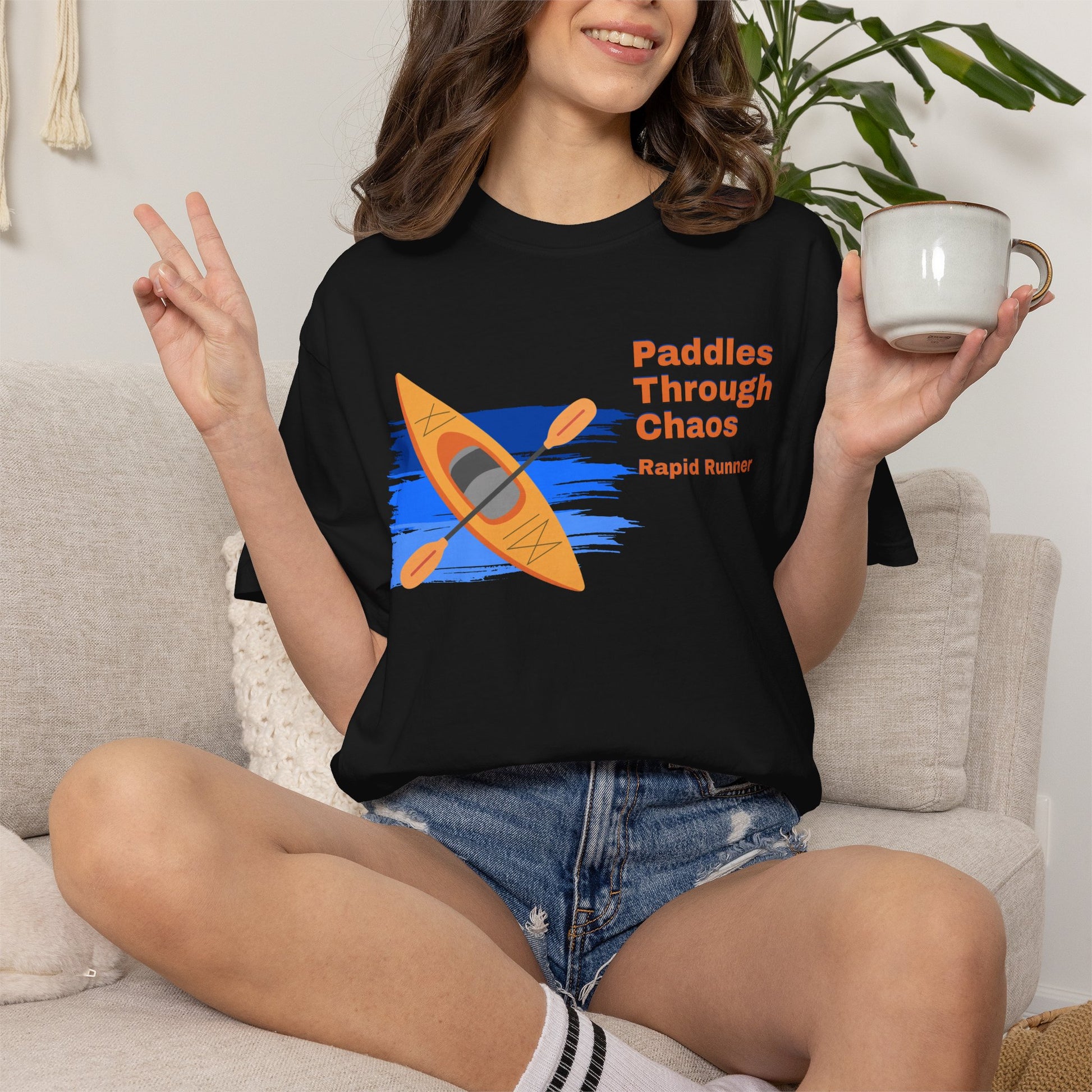 Outdoor enthusiast shirt folded showing yellow kayak rapids artwork