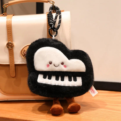 Piano keychain pendant 16 cm version held in hand to show portable size and soft plush texture