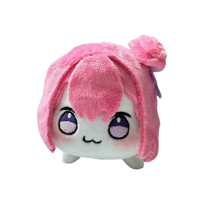 Pink Doro plush keychain displayed on a gaming desk setup
