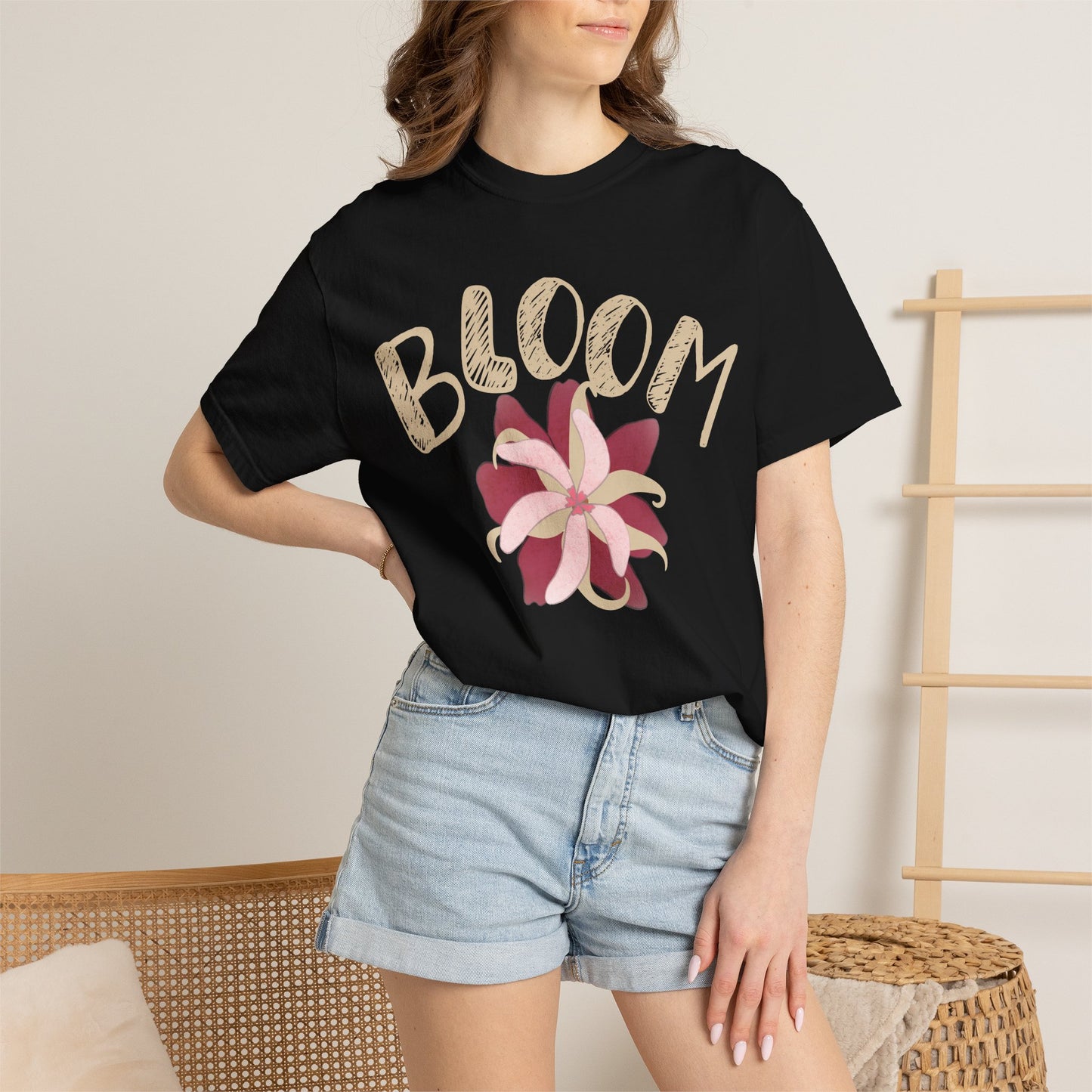Pink blossom graphic tee detail shot showing garment-dye texture and ink petal illustration