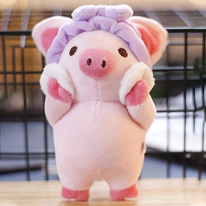 Pink pig plushie keychain attached to bag strap lifestyle shot
