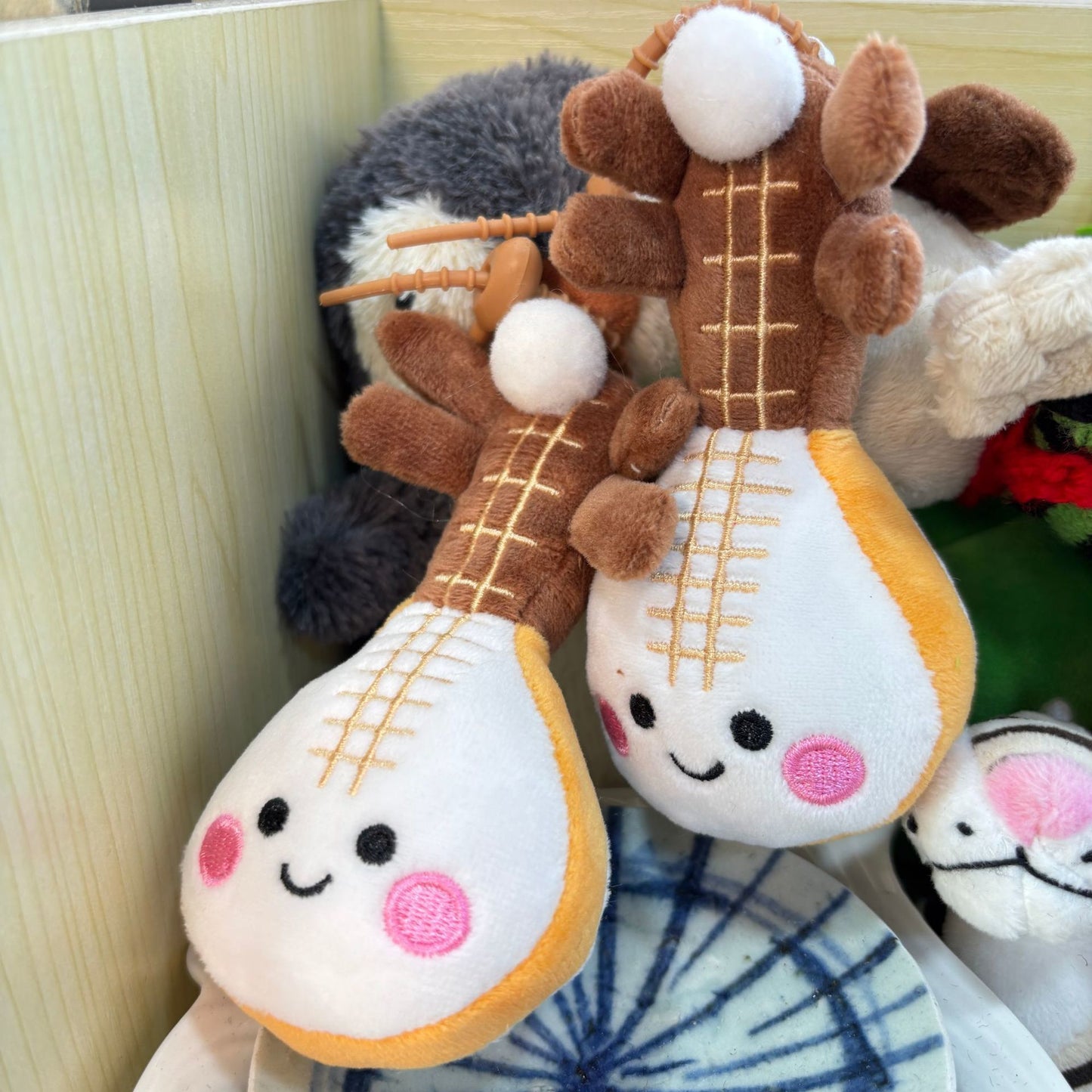 Pipa lute plushie with pear-shaped body and four string detail close up