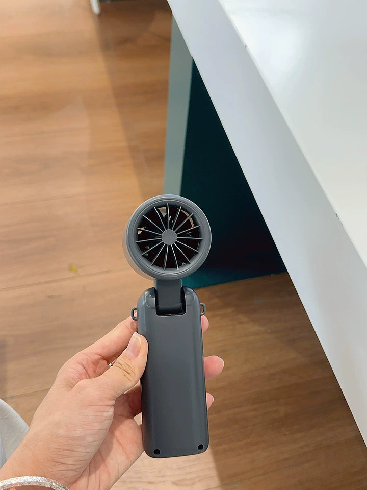 Portable cooling fan in purple color variant against light background
