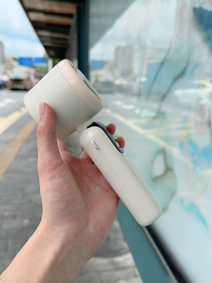 Portable fan standing upright in desktop mode on flat surface
