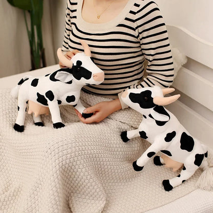 Poseable cow plush toy shown in multiple standing postures on white background