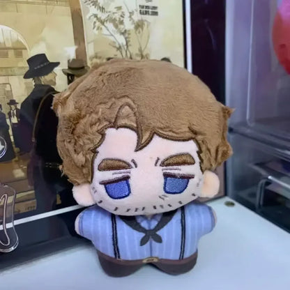 RDR2 plush figures displayed on gaming desk next to controller
