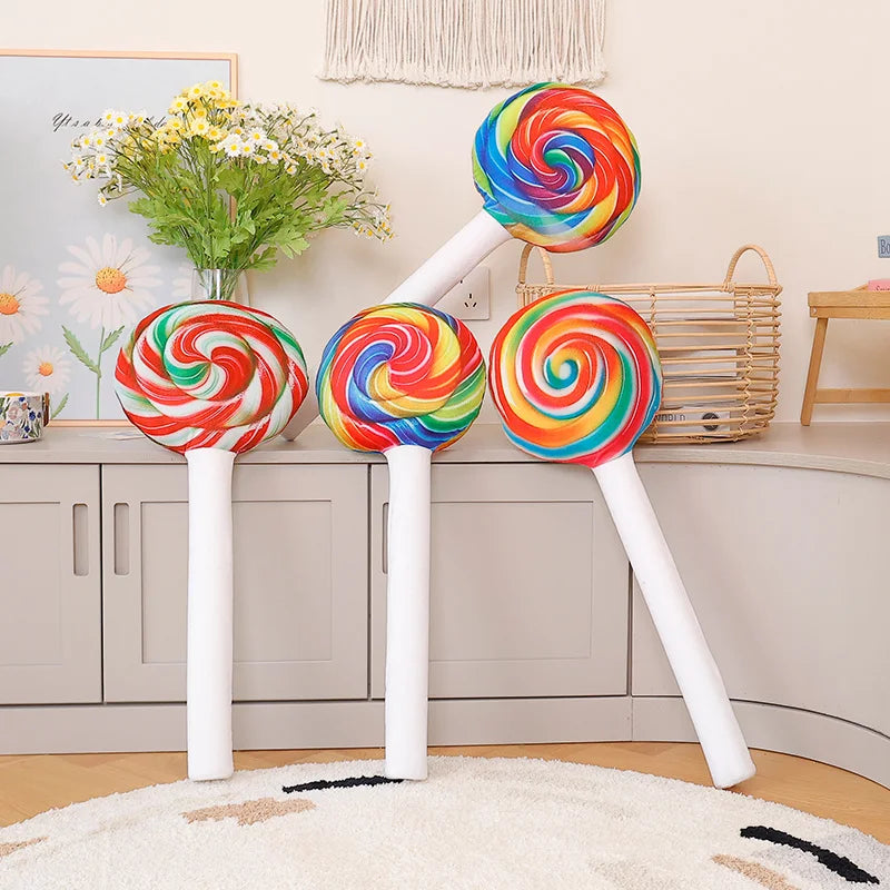 Rainbow lollipop plush pillow close up showing vibrant cotton swirl pattern and texture