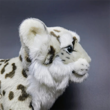 Realistic snow leopard plush size comparison next to hand