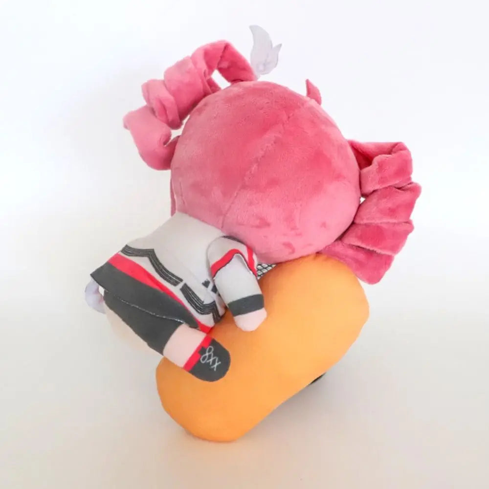 Red-haired Kasane Teto plushie sitting on a shelf.