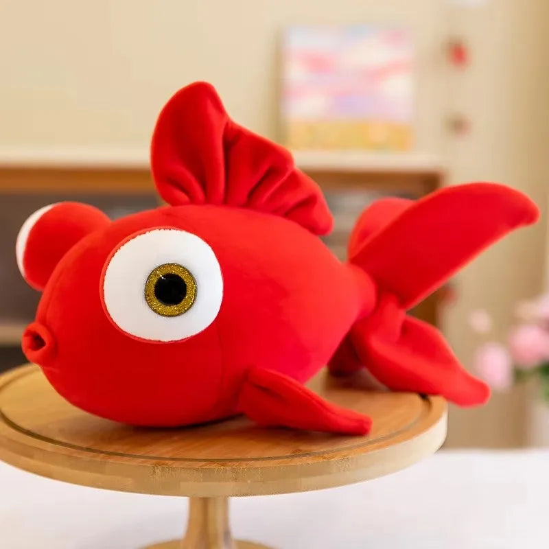 Red kawaii fish plush, side profile view showing round chonky body