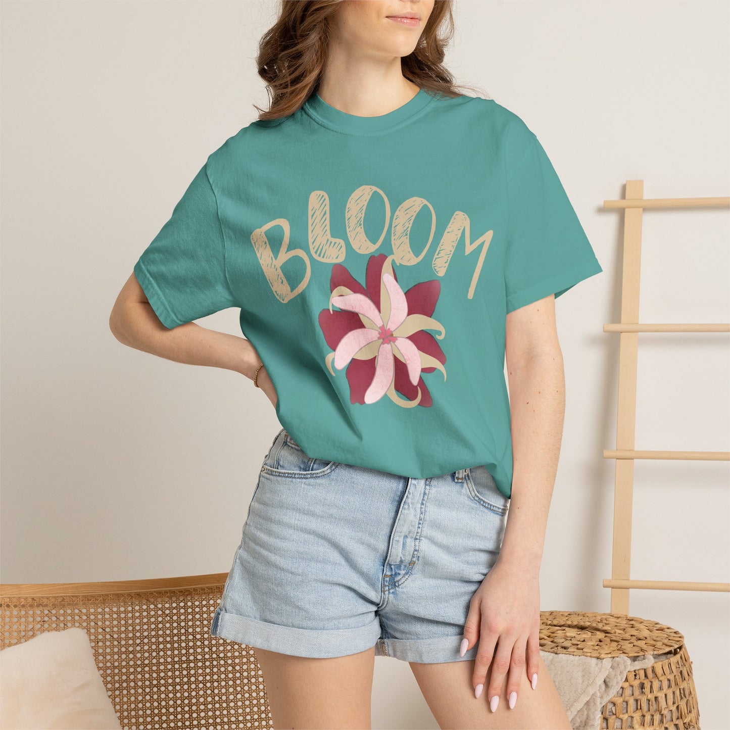 Retro floral graphic tee on model seated in balcony garden, holding coffee mug
