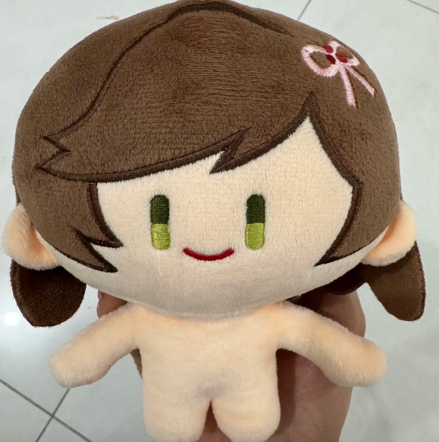 Rosa chibi plush with clothes, side angle showing fabric texture and outfit stitching