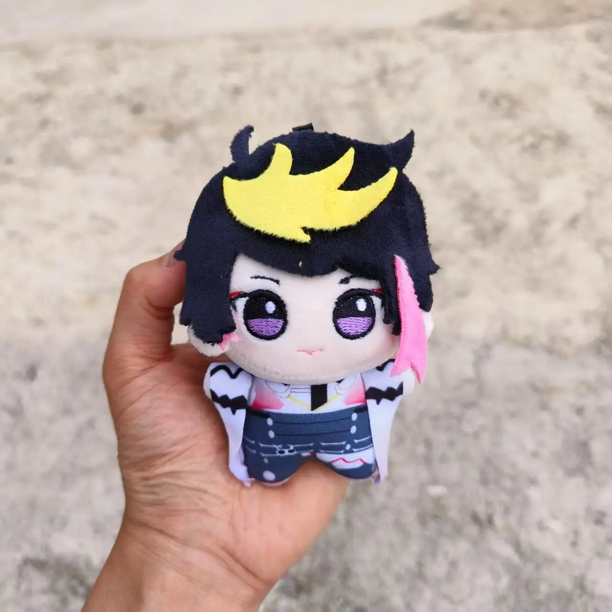 Flat lay of Shu Yamino plush keychain showing dark sorcerer character design, fanmade Shu Yamino merchandise for kawaii collectors