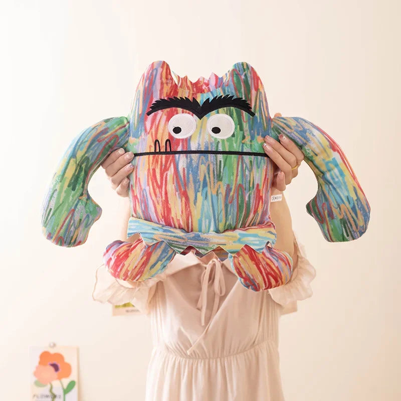 SEL plush toy emotion monster displayed alongside a children's emotion learning chart