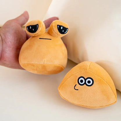 Sad Pou meme plush sitting on a desk next to a keyboard, 22cm brown variant