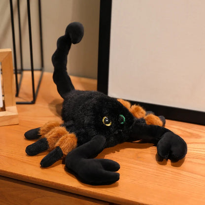 Scorpion plush toy displayed next to Halloween pumpkin and spider web decoration for seasonal styling