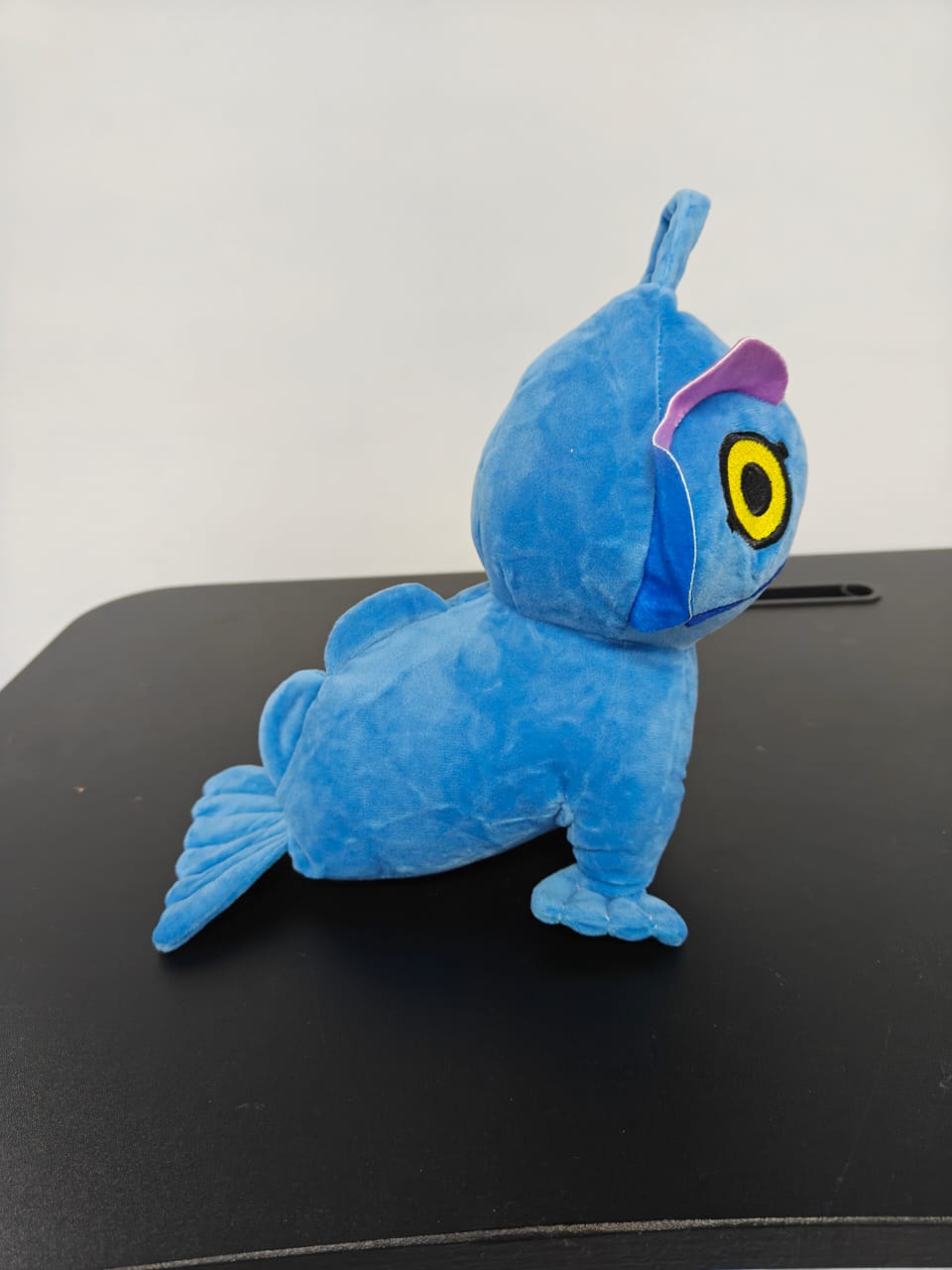 Sea monster plush toy sitting upright on weighted base, cute kraken inspired ocean creature plushie