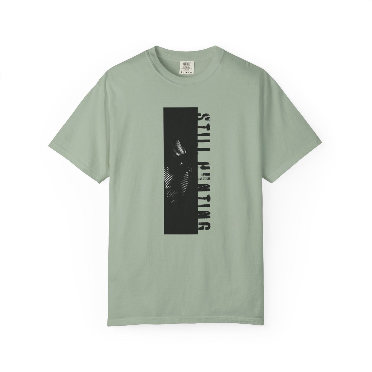 Shadow investigator graphic tee flat lay dark surface moody styled product shot
