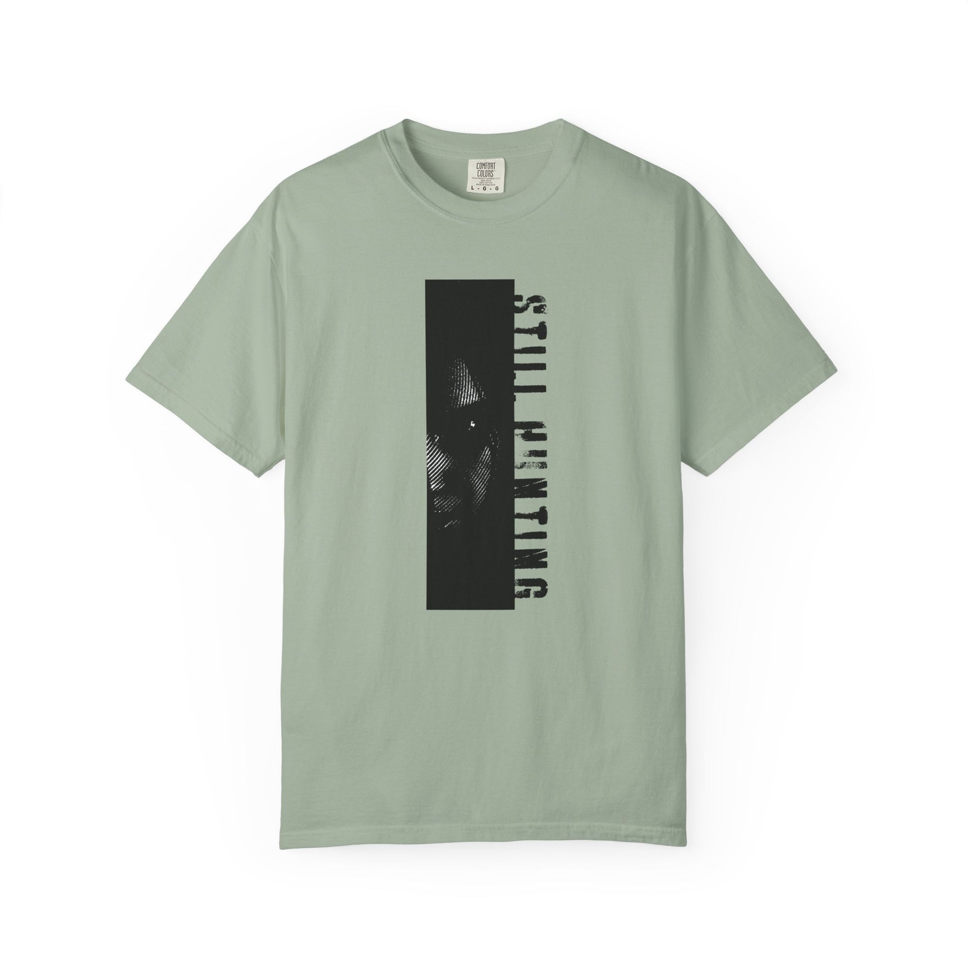 Shadow investigator graphic tee flat lay dark surface moody styled product shot

