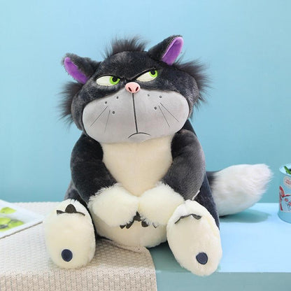 Side eye cat plushie sitting upright on office desk as humorous desk companion
