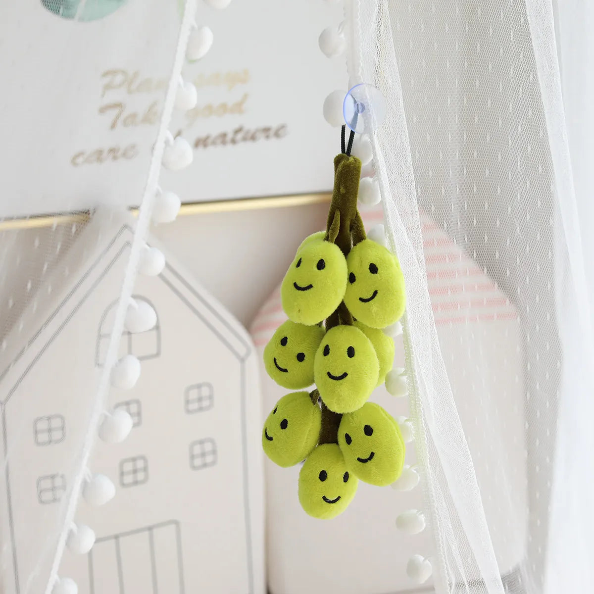 Side view of large smiling grapes plush showing full 26cm height and full grape cluster