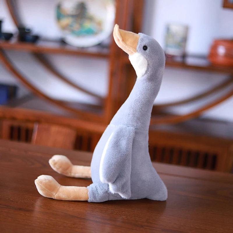 Silly goose plush 35cm sitting upright on wooden shelf