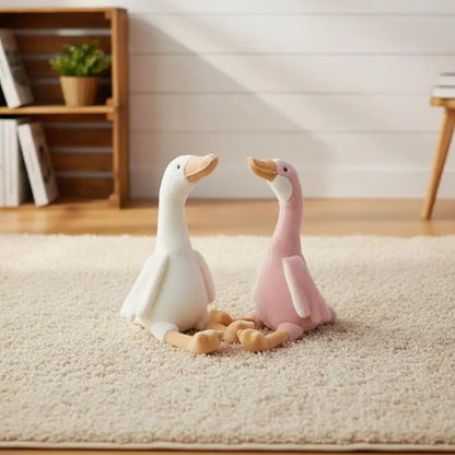 Silly goose plushie sitting on white background front view
