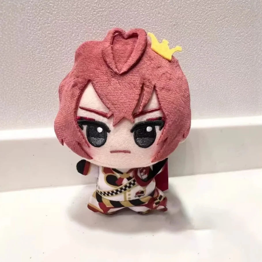 Small soft anime plush figure with red eyes and dark uniform
