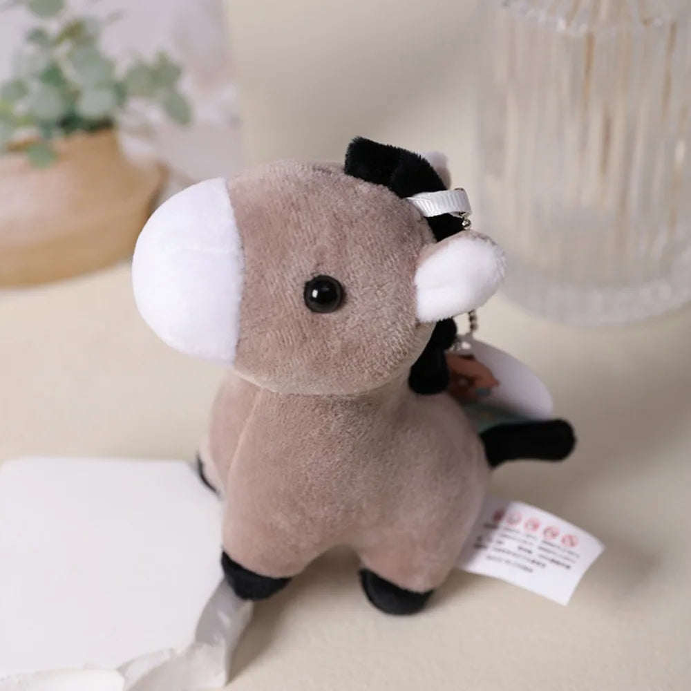 Soft animal bag charm plush keychain clipped to backpack zipper