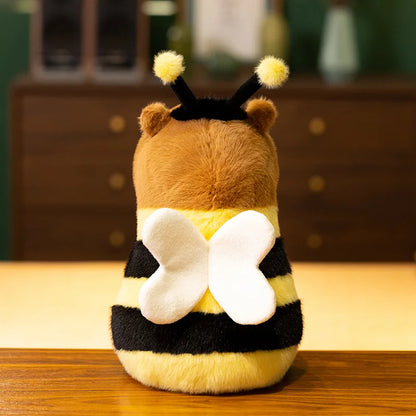 Soft bee capybara plush toy being held in two hands to show 23cm size scale reference
