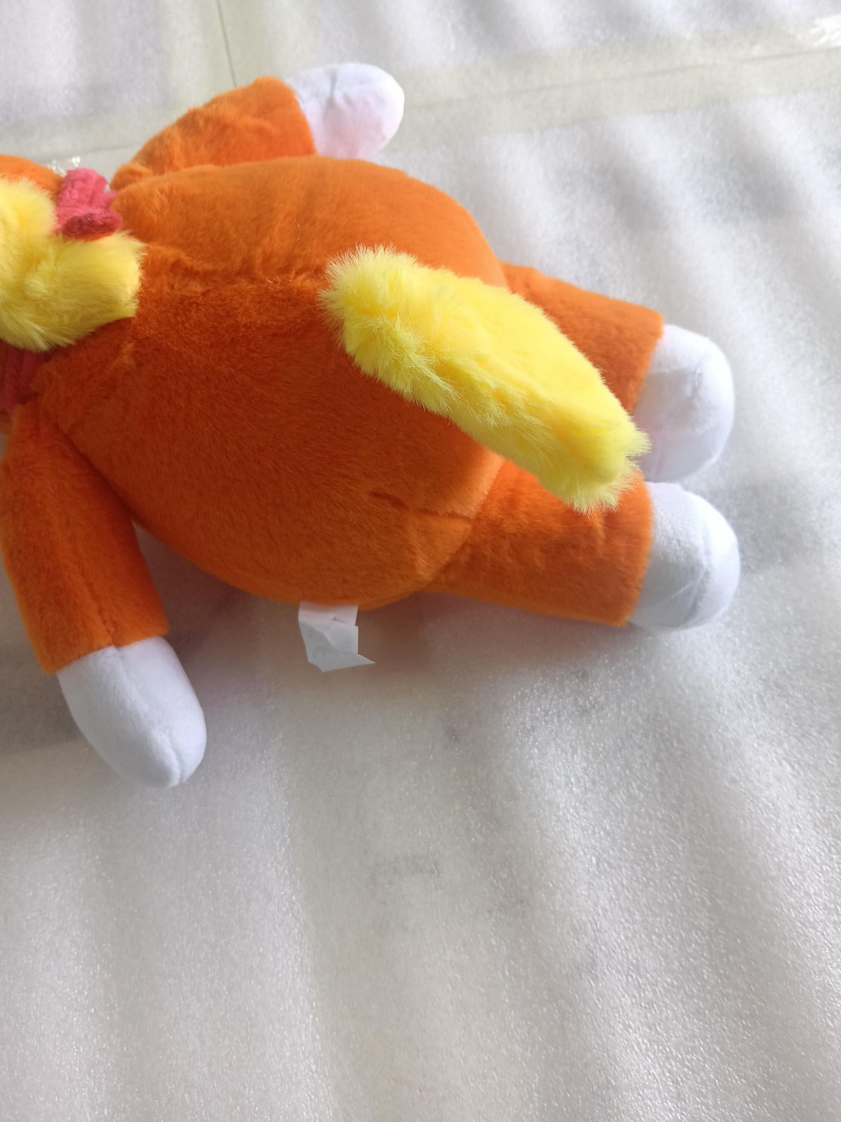Soft_cotton_texture_and_bright_orange_fabric_of_the_handmade_Buddy_the_Unicorn_stuffed_animal_supplier_photo.
