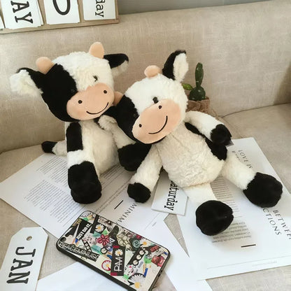 Soft cow stuffed animal 22cm size placed on a wooden surface