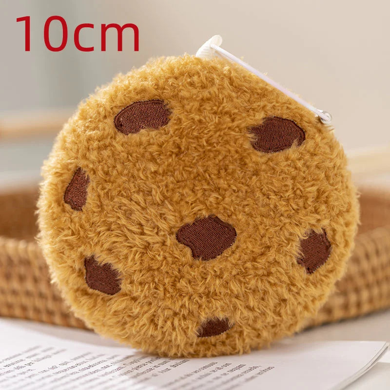 Soft kawaii food pillow cookie plush in warm brown tones styled as aesthetic room decor on a pastel shelf