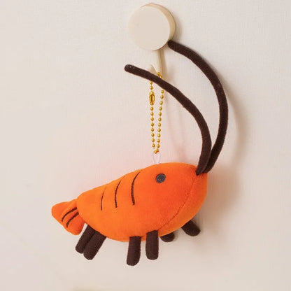 Soft orange prawn stuffed animal keychain - side profile view