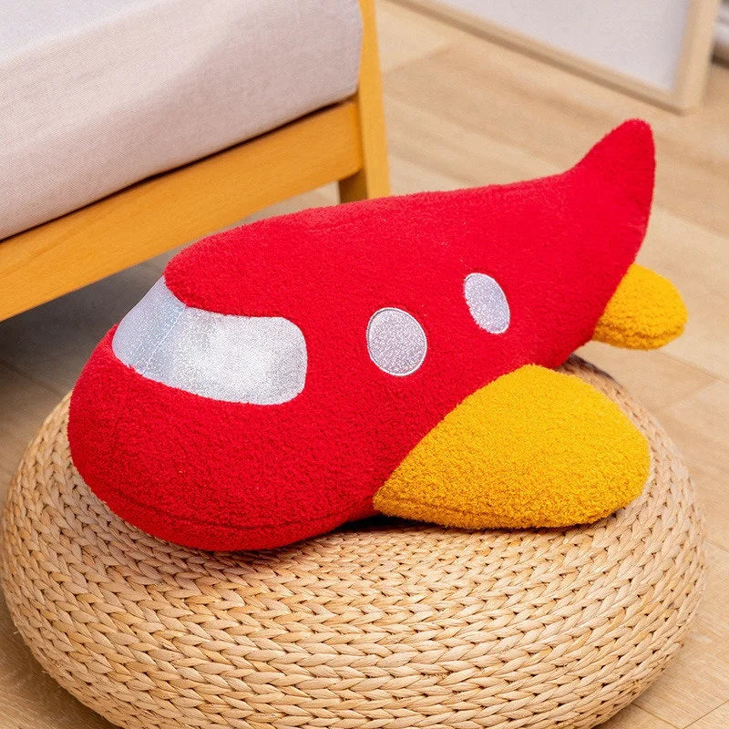 Spaceship stuffed animal displayed as a decorative space themed throw pillow on bed