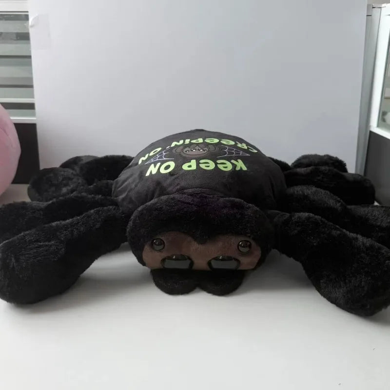 Spider plush with outfit removed showing sleek solid black body and eight stuffed legs