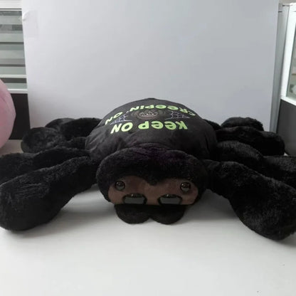 Spider plush with outfit removed showing sleek solid black body and eight stuffed legs