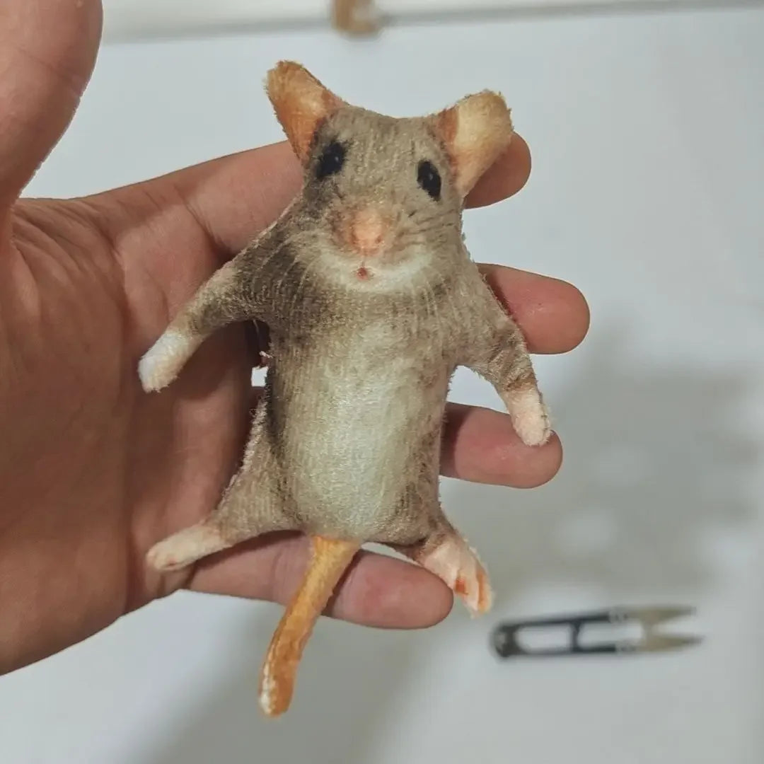 Spoof plush mouse sitting on desk internet culture toy