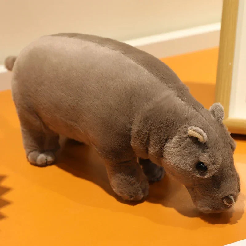 Squishy pygmy hippo plush squeezed gently to show softness