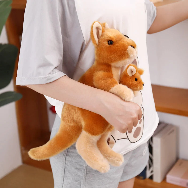 Stuffed kangaroo toy held in hand to show relative size scale