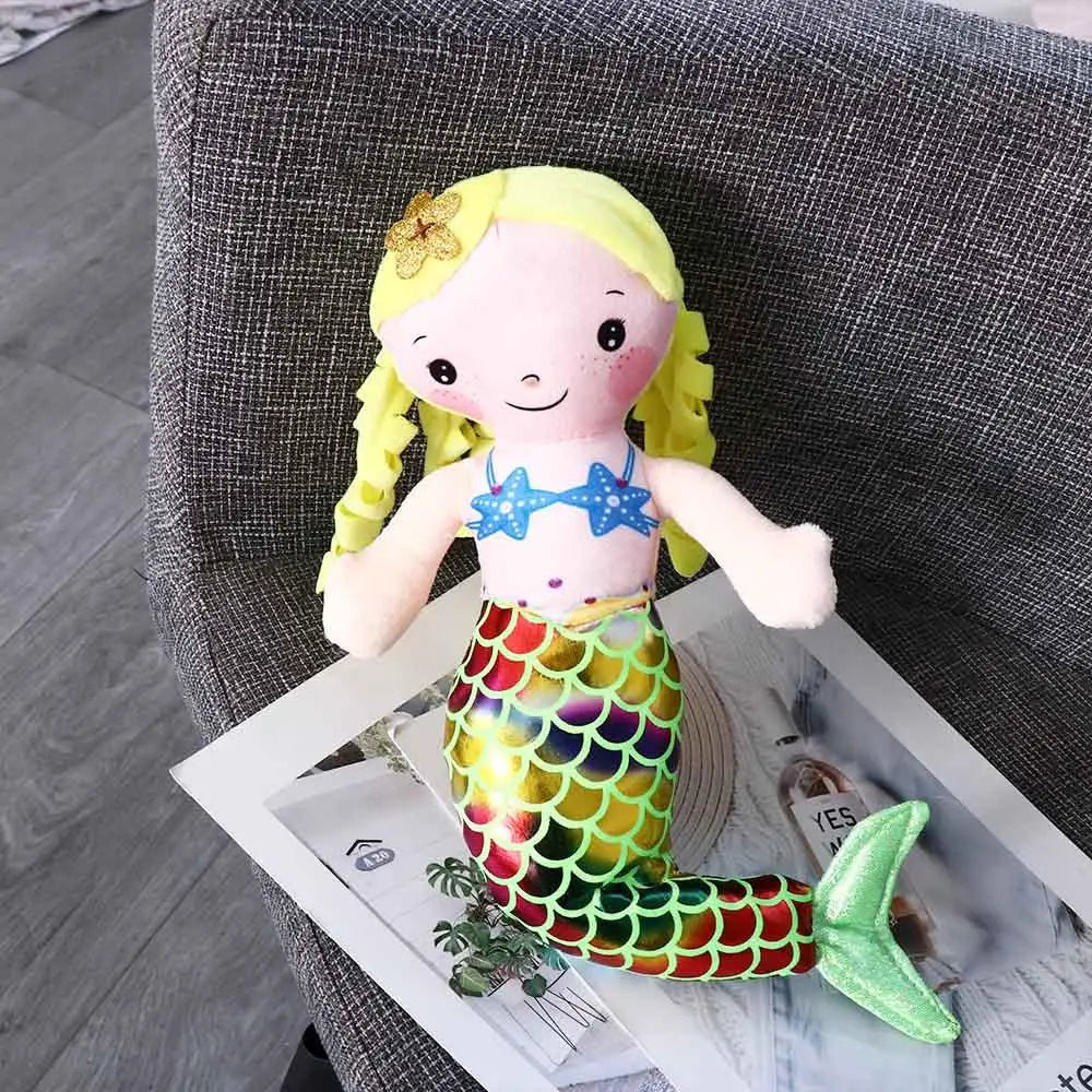 Stuffed mermaid doll standing upright showing full front view