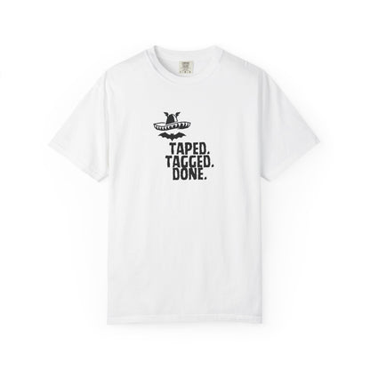 The Midnight Mariachi Taped Tagged Done graphic tee featuring bat winged sombrero design on garment dyed heavyweight cotton shirt