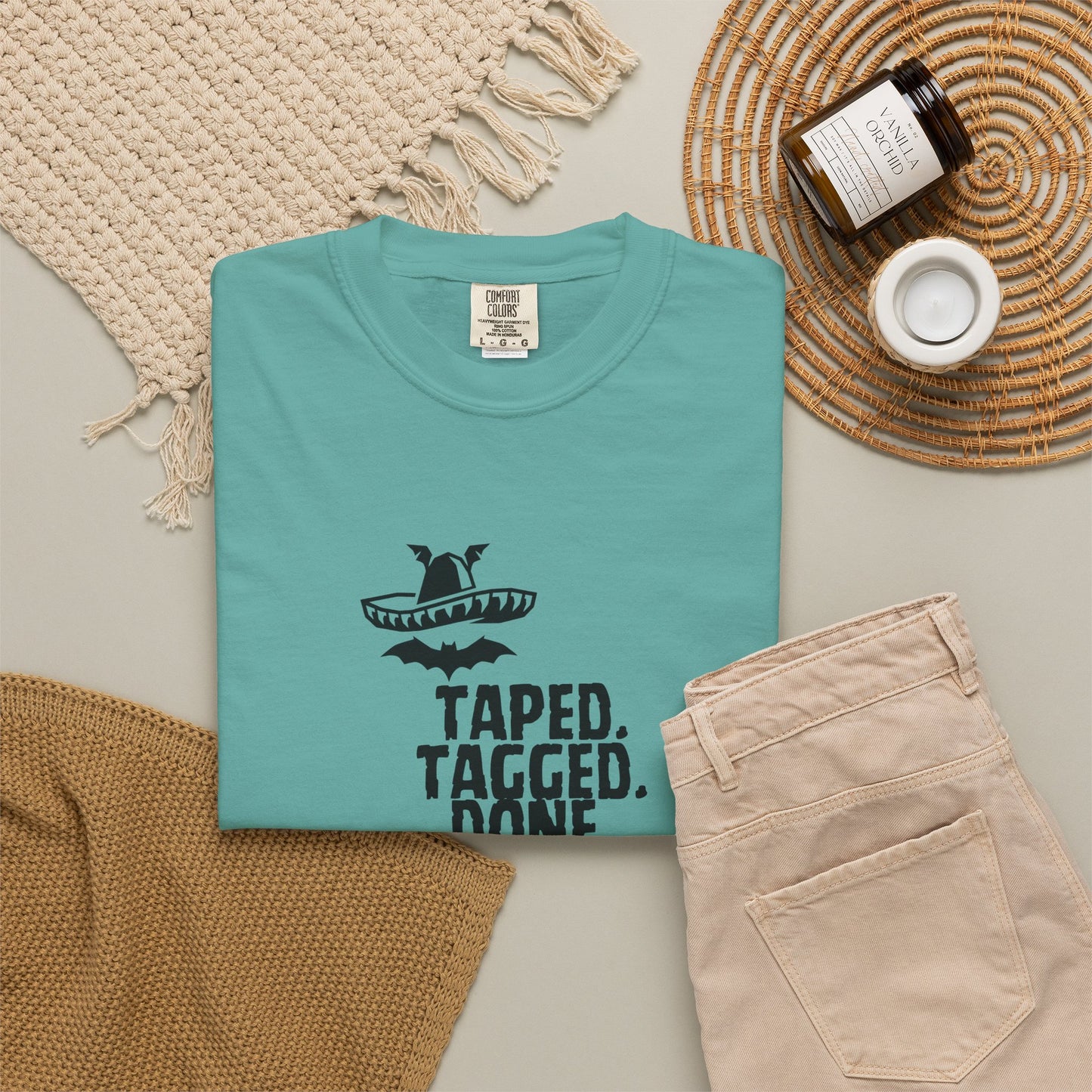 The Midnight Mariachi graphic tee hanging on wooden hanger against concrete wall background
