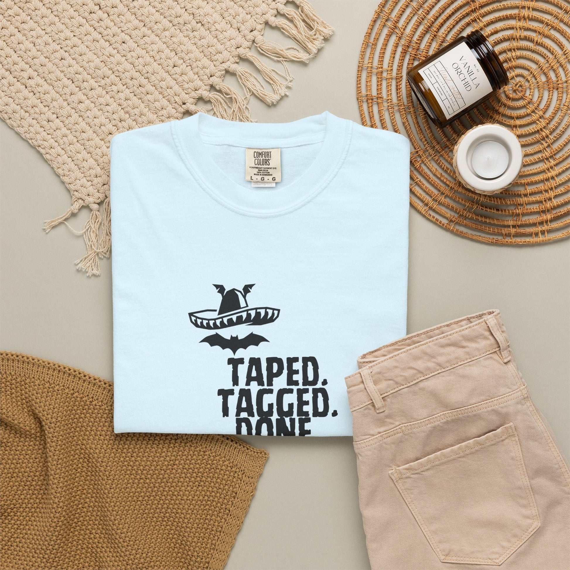 The Midnight Mariachi pop culture mashup tee laid flat on rustic wooden table top
