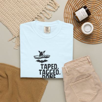 The Midnight Mariachi pop culture mashup tee laid flat on rustic wooden table top
