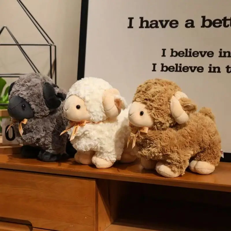 Three color variants of sheep stuffed animal: Black, Brown, White
