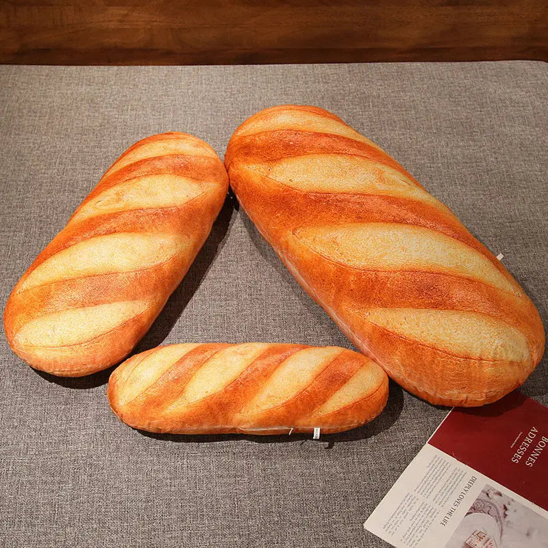 Three loaves of bread on a textured surface with a magazine underneath.