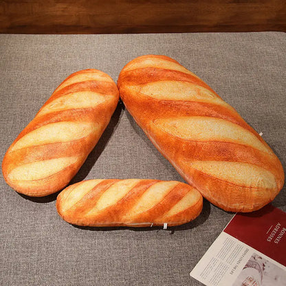 Three loaves of bread on a textured surface with a magazine underneath.